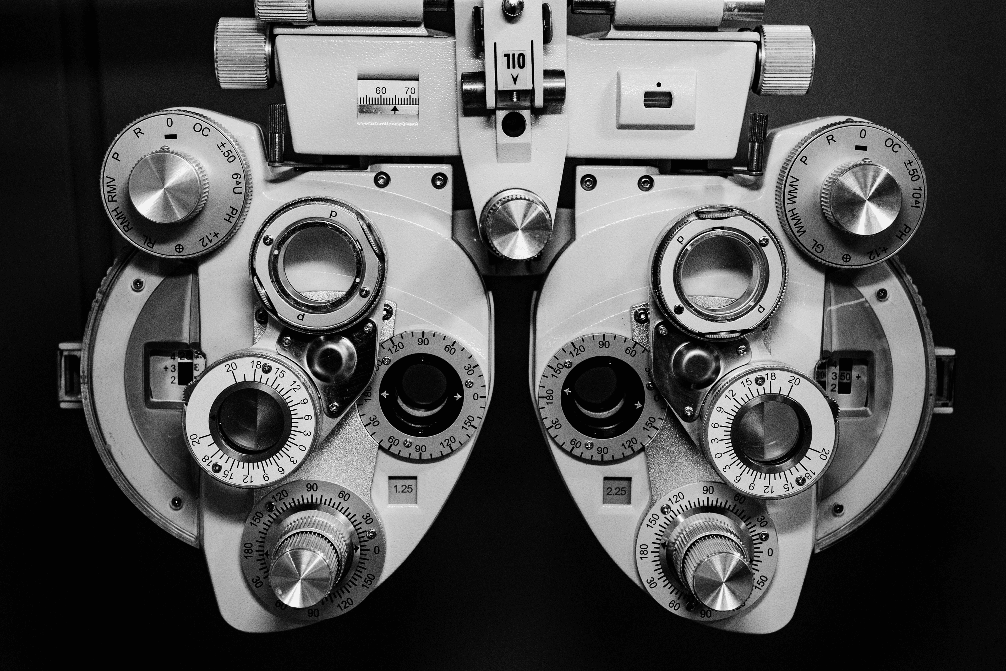 Black and white photo of a phoropter, the optometrist's instrument used to test vision.