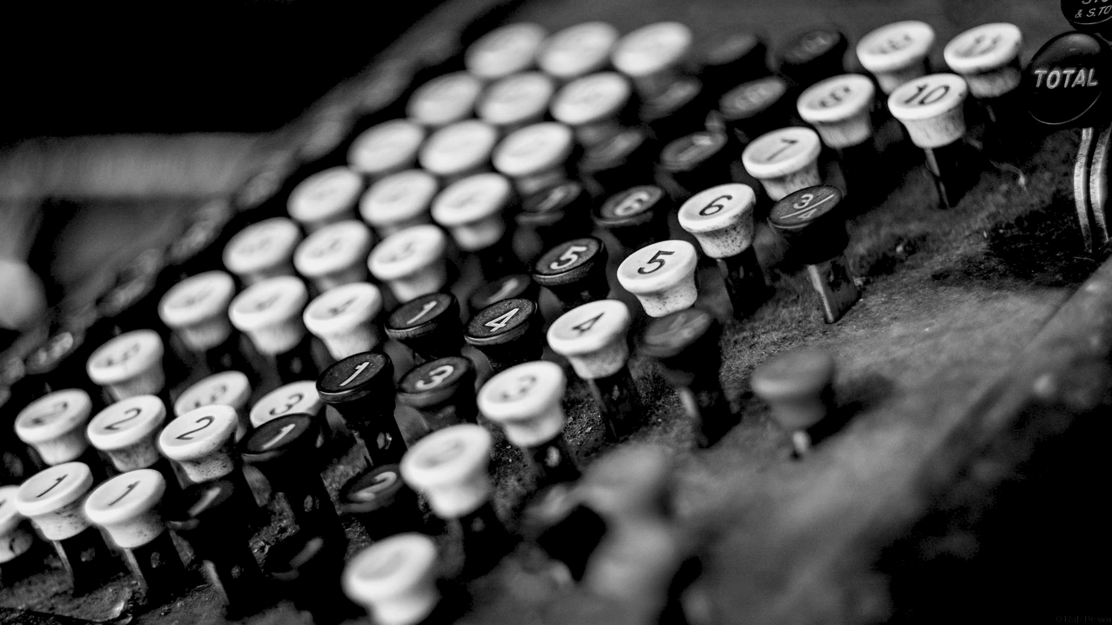 Vintage mechanical adding machine keys with numbers, black and white